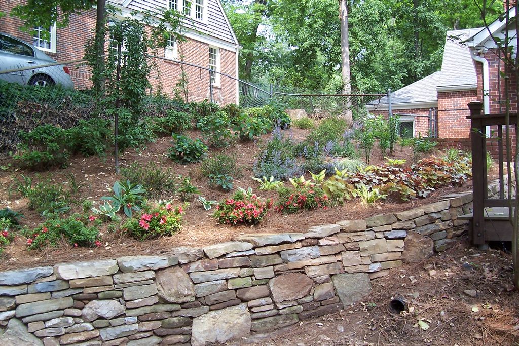 shade garden w/stacked stone wall