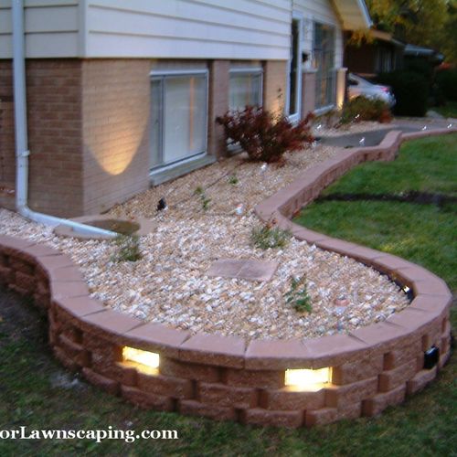 Low profile retaining wall with LED lighted glass 
