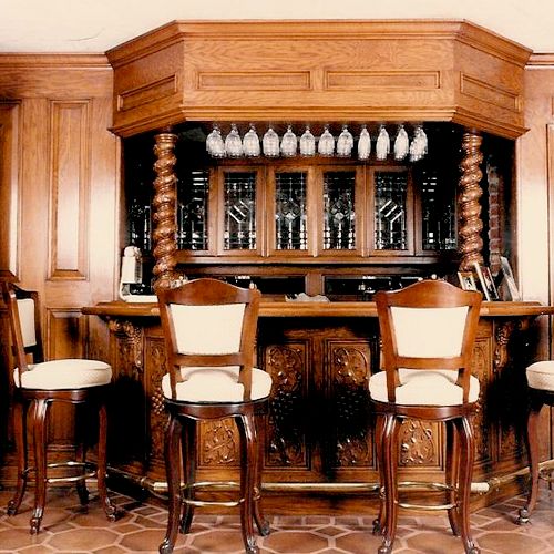 This is a carved wood bar with the entry to the ba