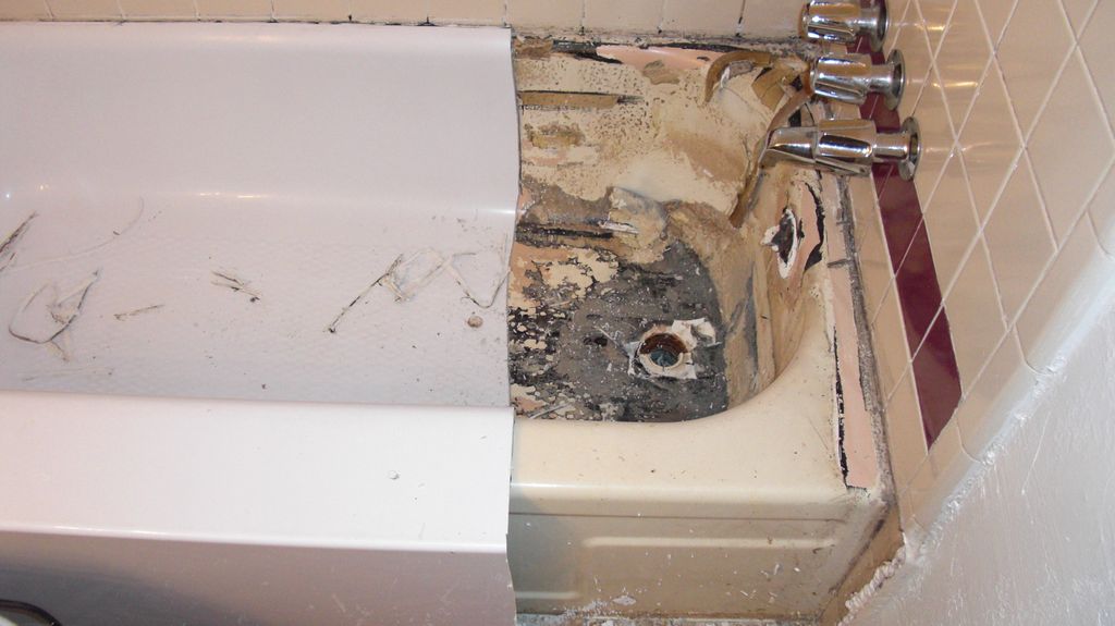 The water is going behind the liner and tub, and c