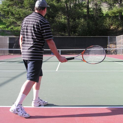 Racquet head above hand at impact for spin and con
