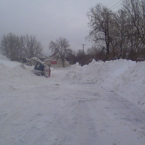 Pushing some snow piles back at one of our lots. L