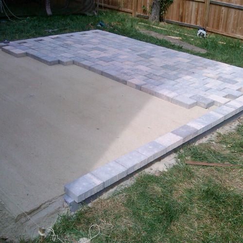 installing patio stones for a raised back yard pat