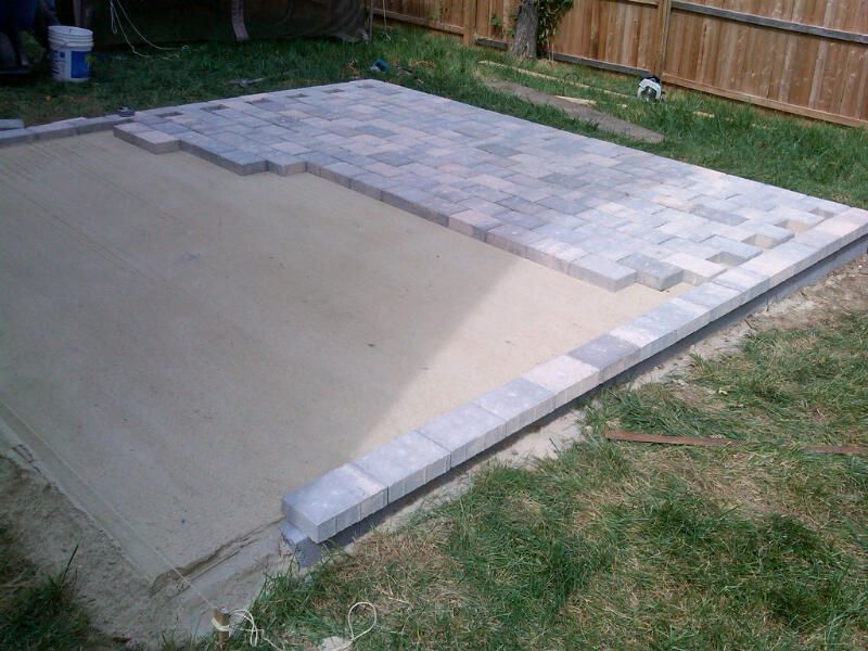 installing patio stones for a raised back yard pat