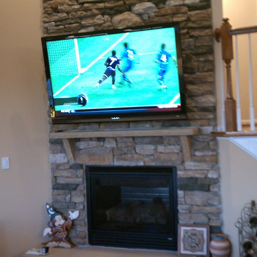 65" LCD with cantilever bracket mounted on a stone