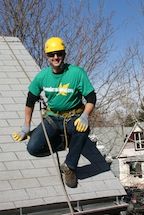 Brian hanging off a rope job cleaning gutters at a