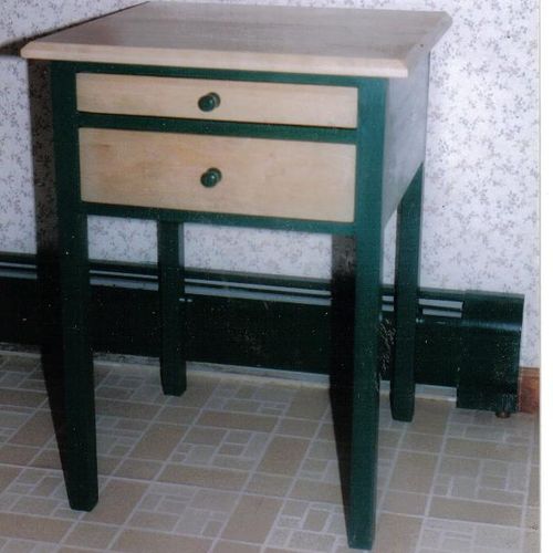 A two drawer table w/ tapered legs. Top & Drawer f