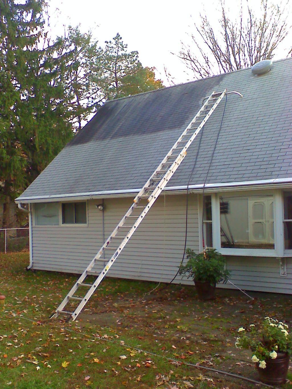 Roof cleaning and sealing in progress.