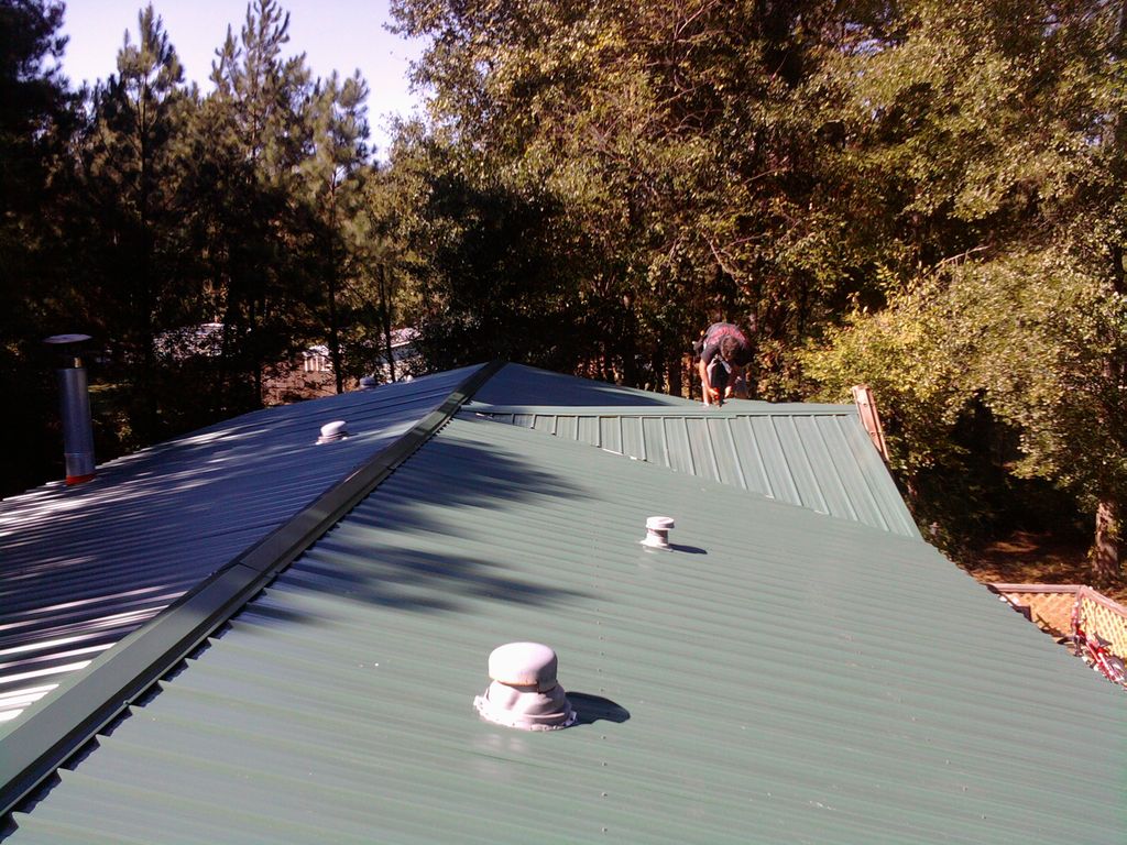 Metal roof installed over shingles on double wide 