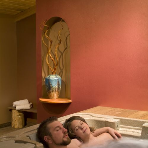 Couple relaxing in the Fire Room hot tub.