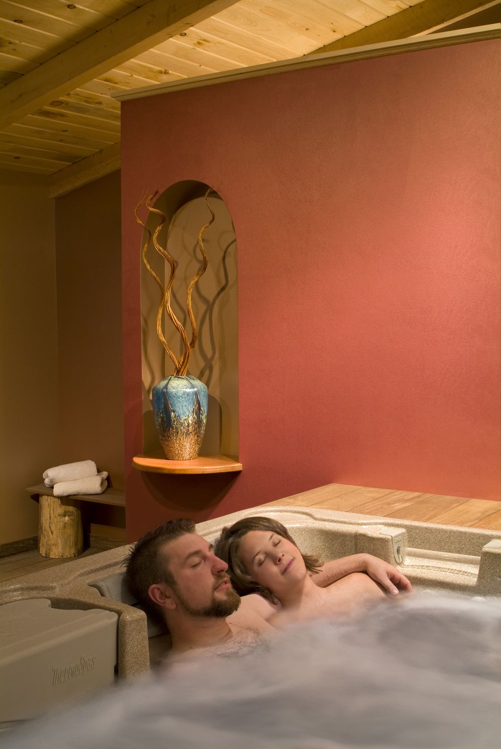 Couple relaxing in the Fire Room hot tub.