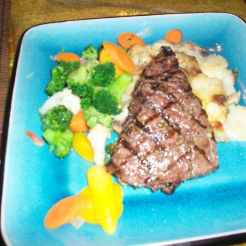 sirloin steik with potatoe lasagna and vegetables.