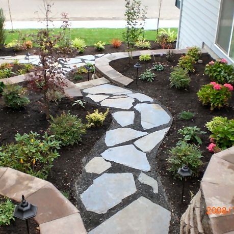 Multi level retaining walls, plantings & flagstone