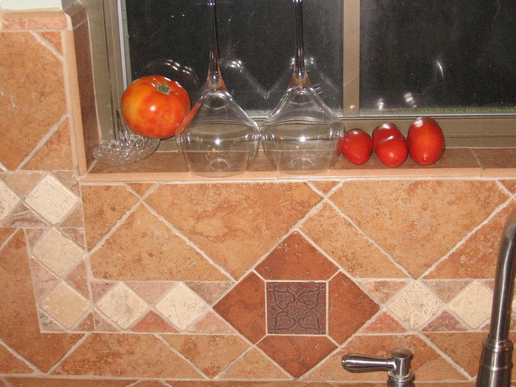 Countertop and backsplash with mosaic inlays.