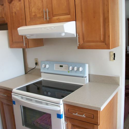 New stove , exhaust fan , cabinets & counter tops