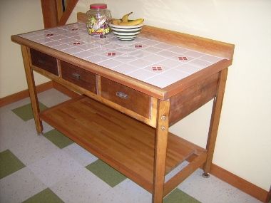 Reclaimed buffet table with new tiled top. Saved f
