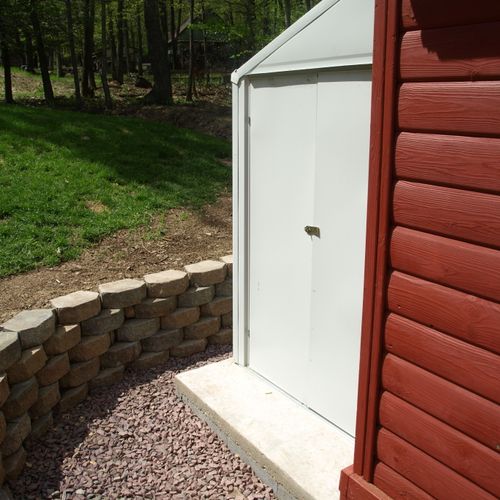 Shed with shed metal kit and retaining wall