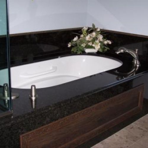 Custom soaker tub with black granite top.