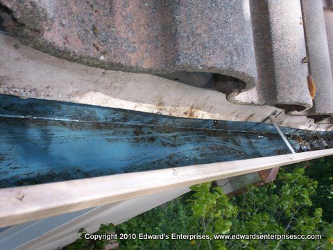 A rain gutter that has been hand cleaned and rinse