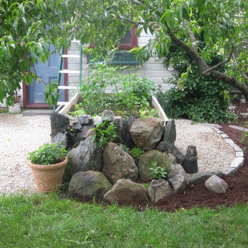 Raised vegetable garden with stone ends.