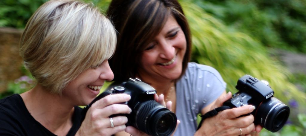 Two women laughing and having fun as they learn ho