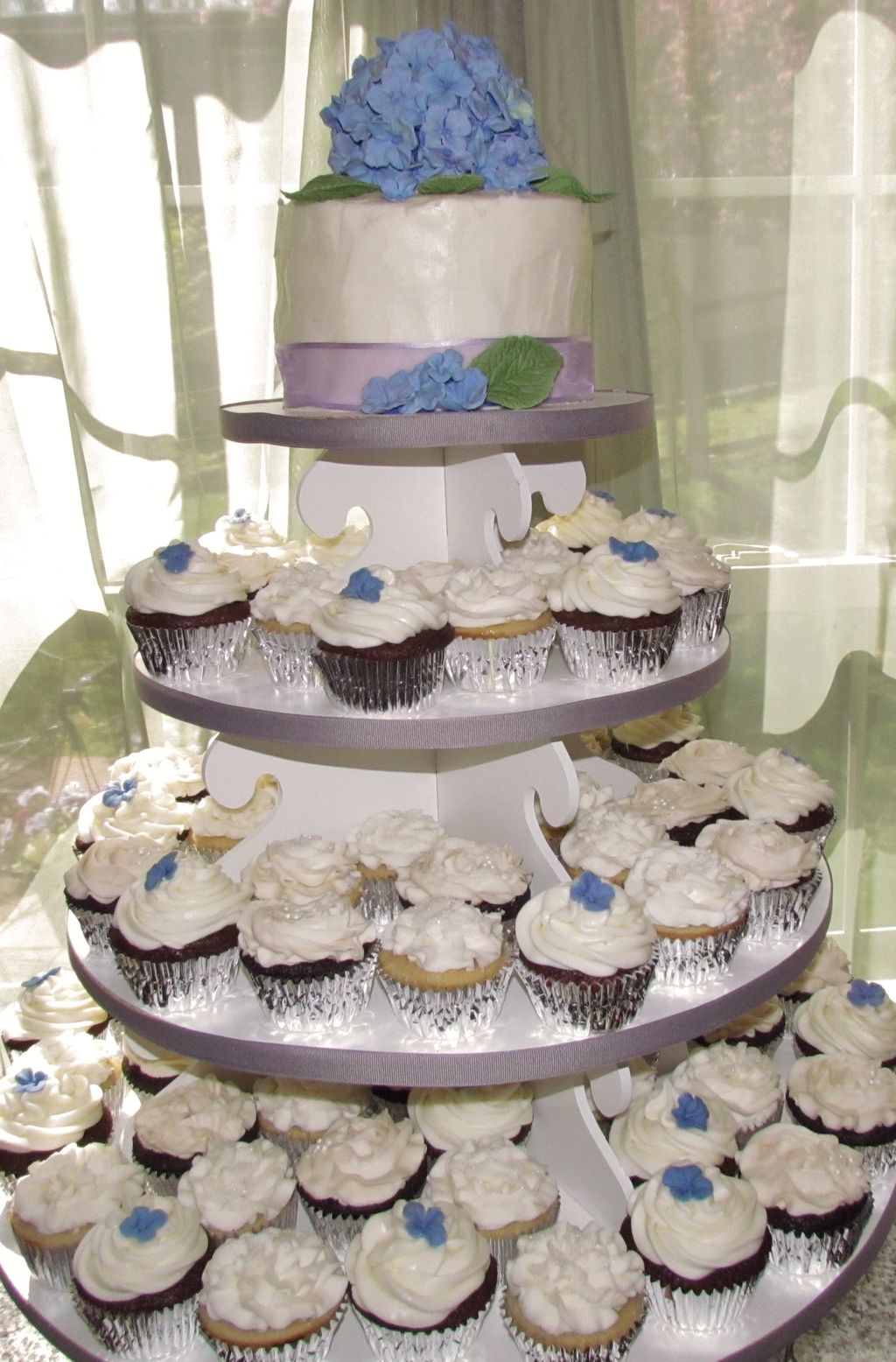 Cupcake towers with a cake topper make a statement