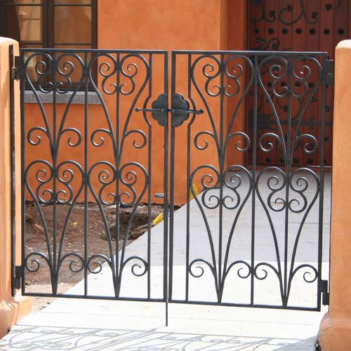 A custom set of hand forged gates at an entry cour