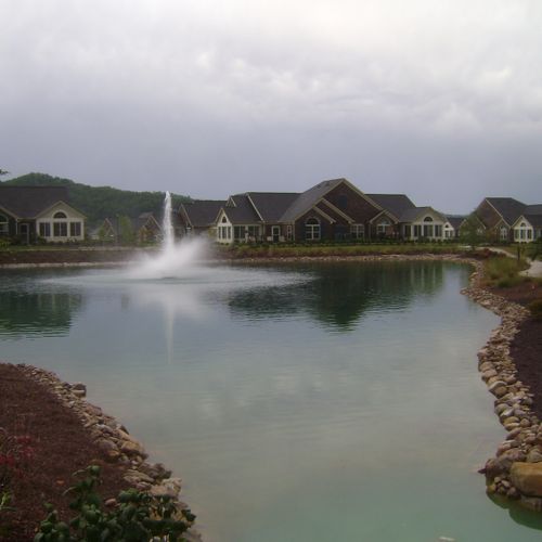 Pond with fountain in subdivision
