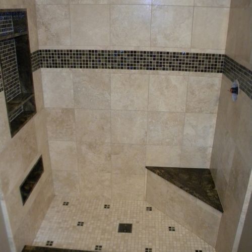 Torreon stone shower with mosaic glass accents
