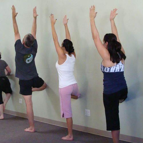 Using the wall to learn balance in tree pose
