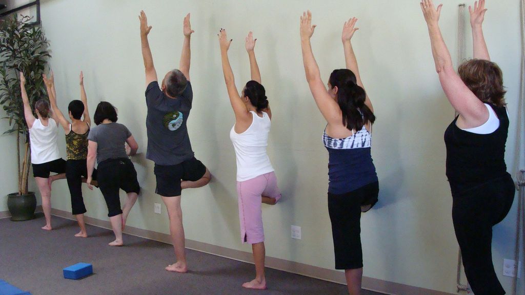 Using the wall to learn balance in tree pose