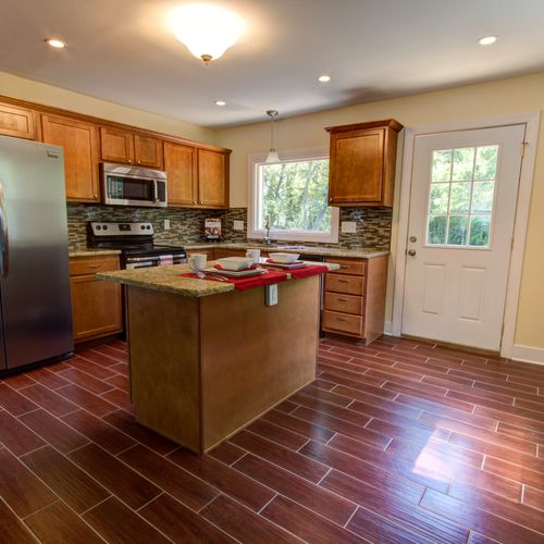 New kitchen with tile (hardwood looking floors)