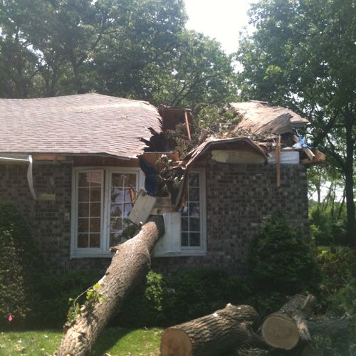Tree through a house after a severe storm.