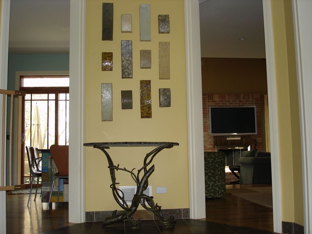Entry foyer with original artwork, custom table ba