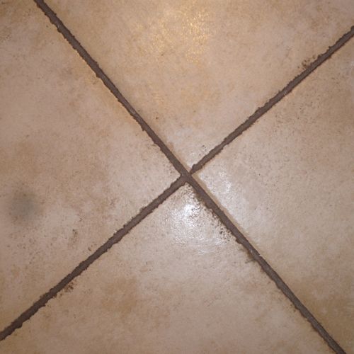 Dirty tile and grout in a commercial restroom