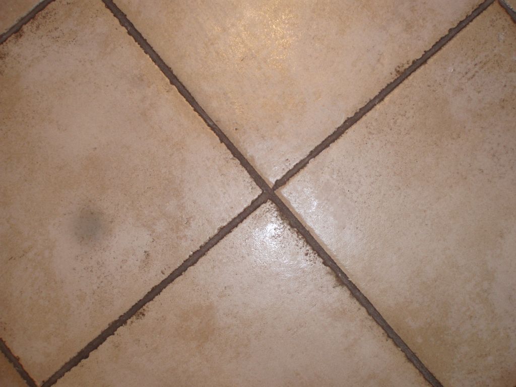 Dirty tile and grout in a commercial restroom