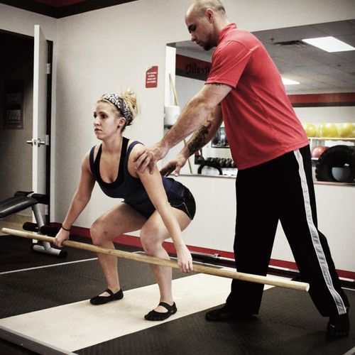 Trainer instructing technique for power lifting