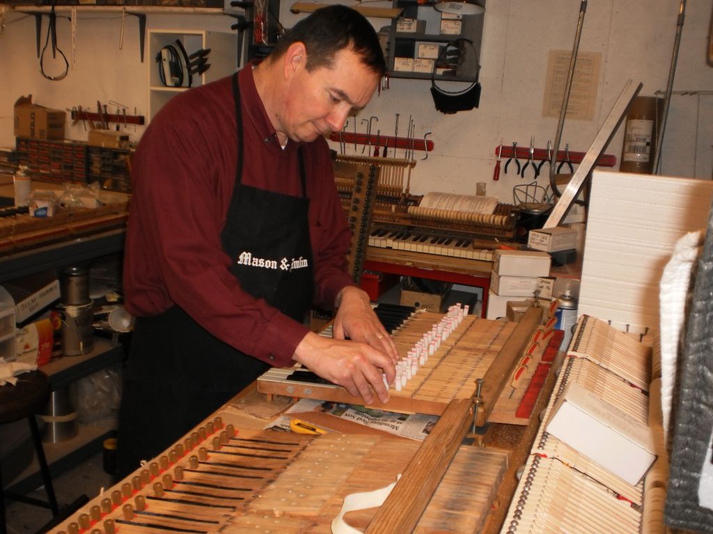 Rebushing piano keys with new felt.