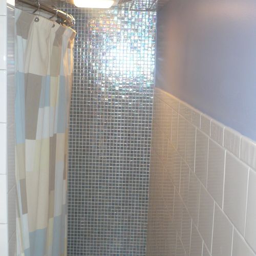 Glass tile on wall, and mosaic on floor