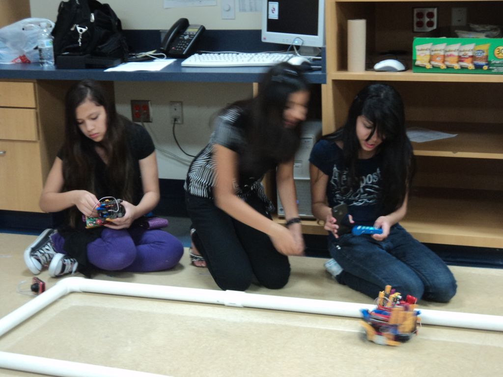 Campers at a day camp, working their robots throug