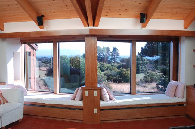 Beach house living room windows and window seats. 