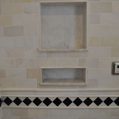 Recessed soap and shampoo box in shower area.