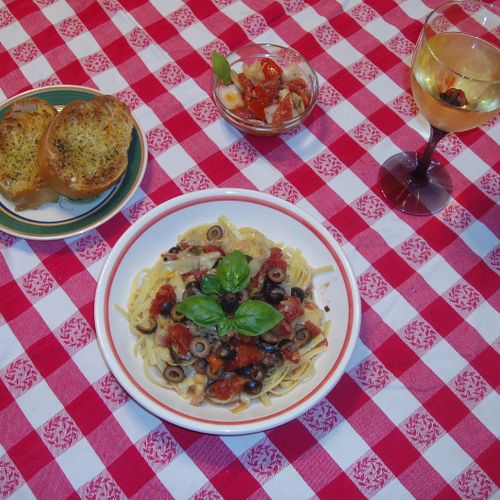 Pasta Puttanesca with tomato/onion salad and a sid