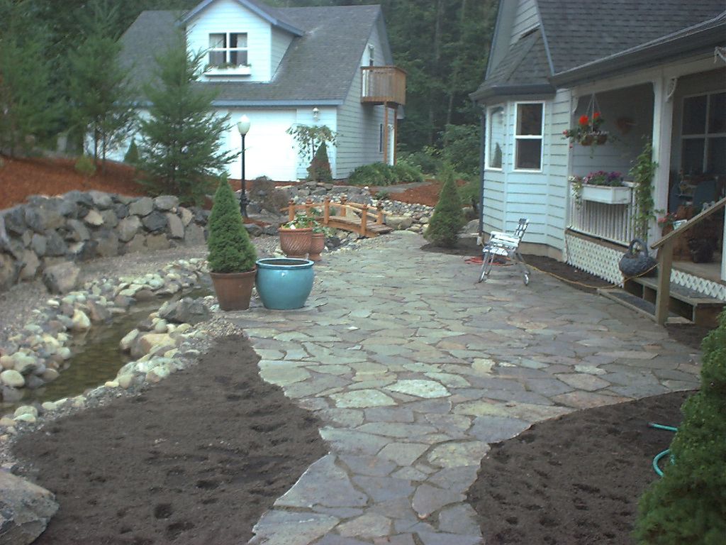 Lazy stream courtyard with flagstone sitting area