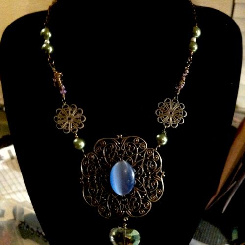 Large antiqued style pendent necklace with green g