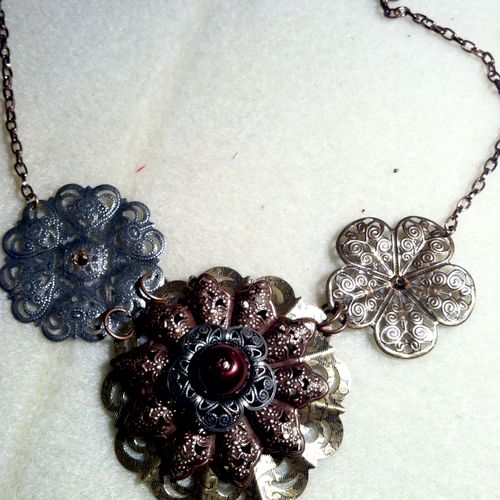 metal base necklace with flower components each pi