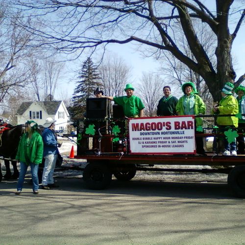 In a parade for Magoos bar, being an emcee and pla