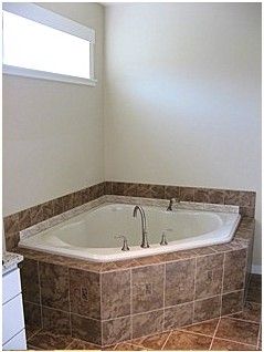 This Corner Jetted Soaker Tub has the durability a