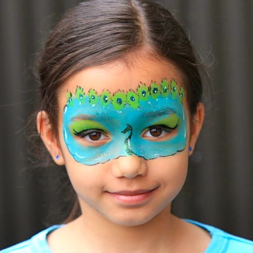 A peacock face painting design by face painter Kik