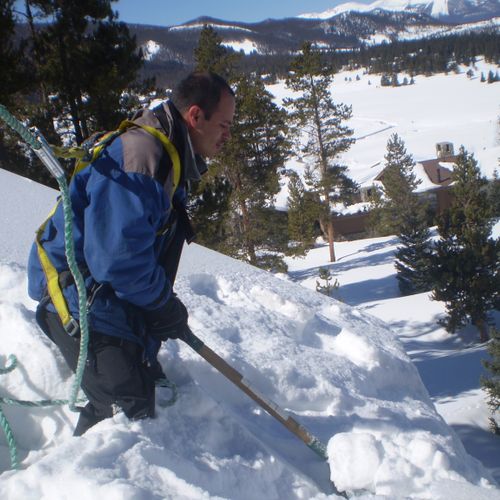 Shoveling snow from a roof in Keystone Ranch #1